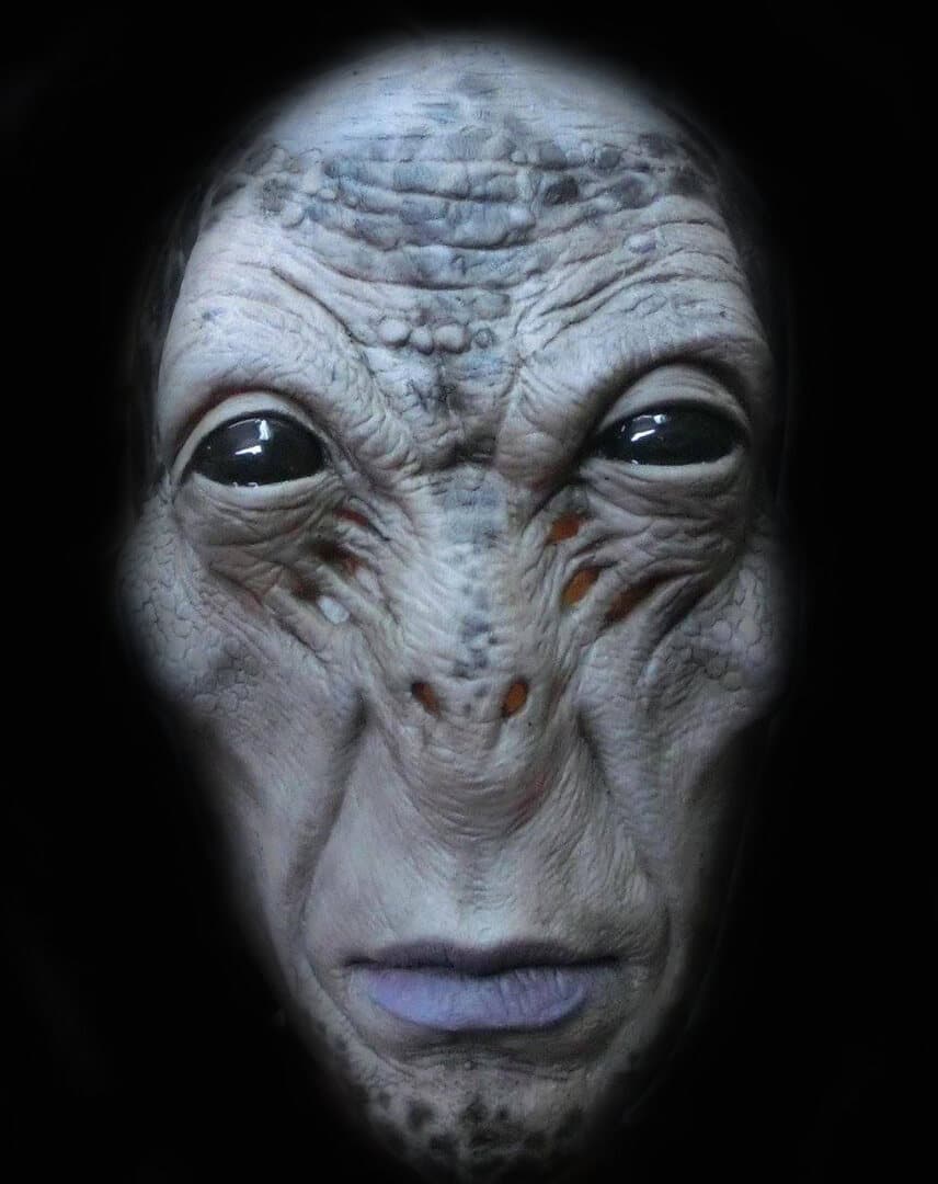 Latex alien facemask with large dark eyes