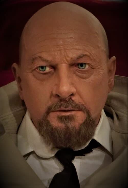 Life-size latex portrait bust of a bearded man in a suit